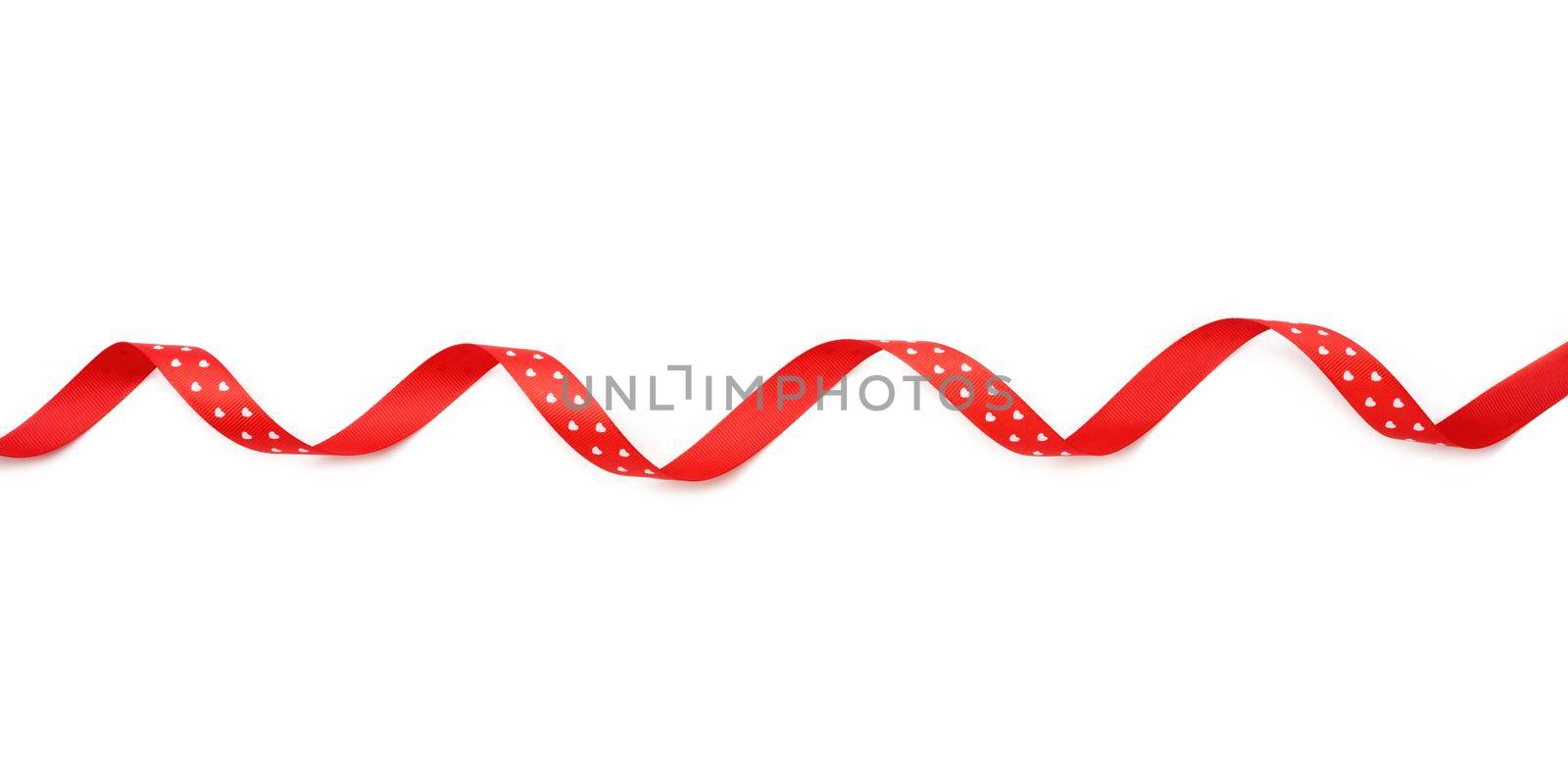 swirling red silk ribbon on white background, gift wrapping decor