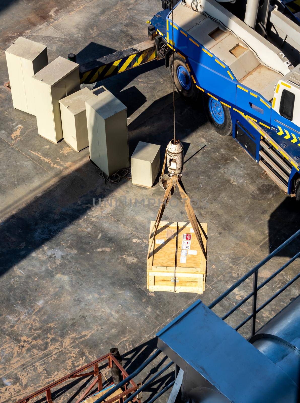 The crane lifting the radioactive instrument holder transportation wooden box by Satakorn