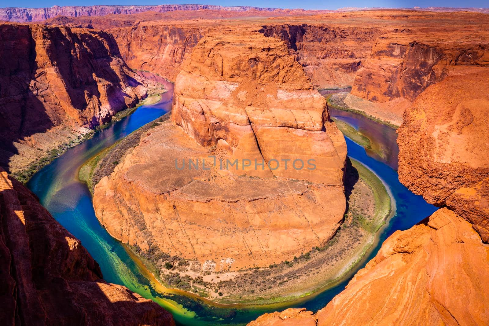 Horseshoe Bend above emerald Colorado River at sunset, Page, Arizona, United States