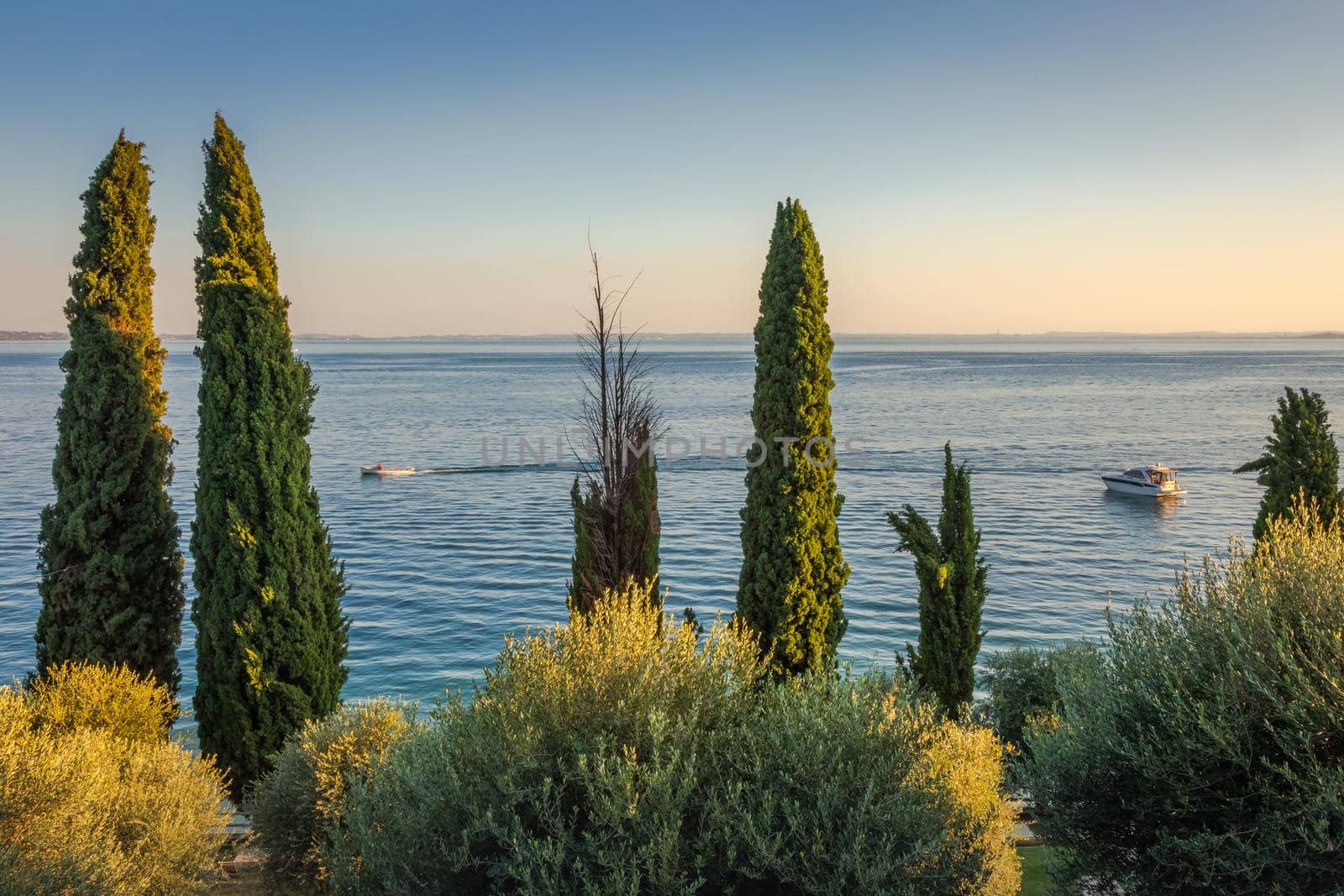 Idyllic lake Garda coastline in Lazise ar peacful sunset, Northern Italy