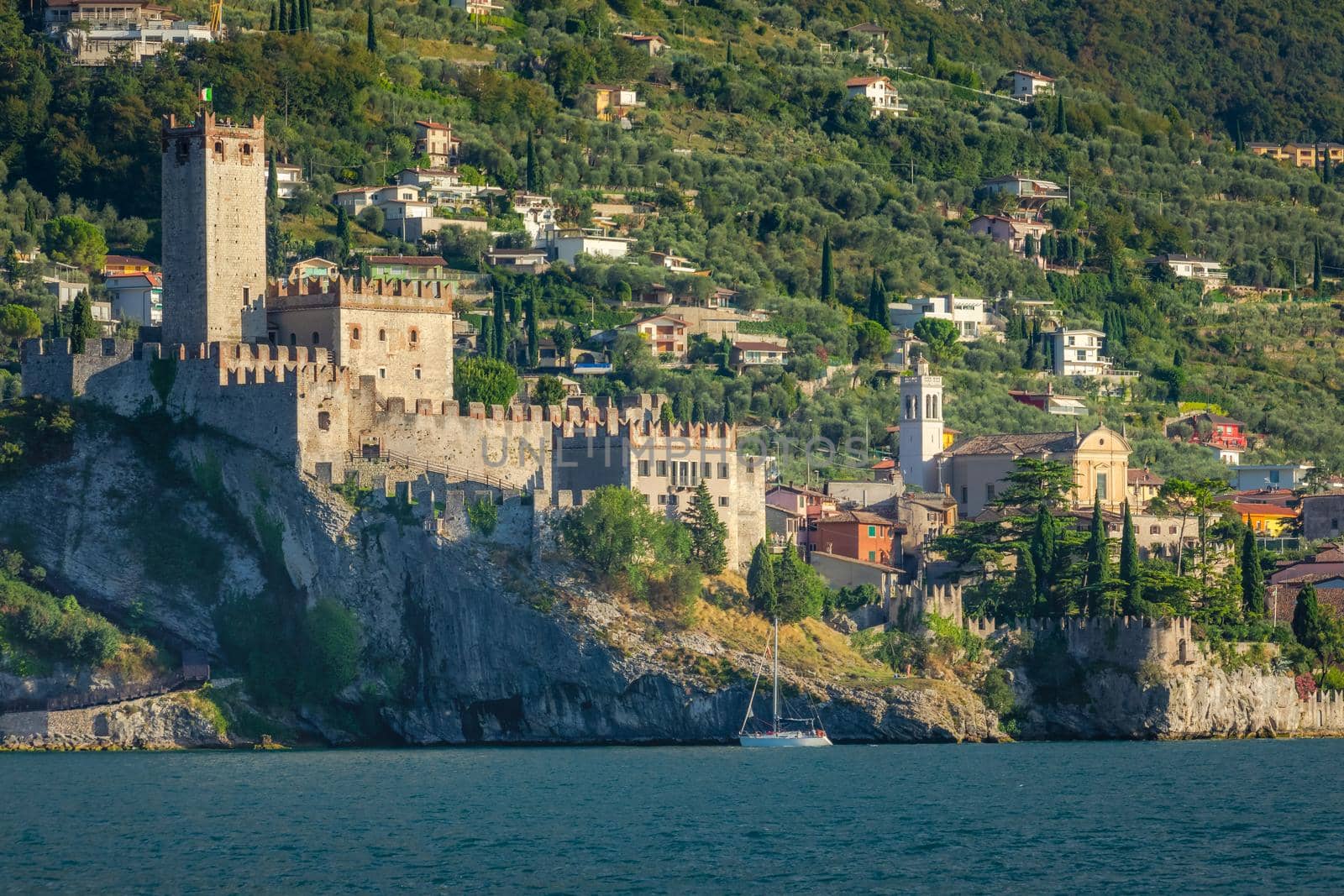 Idyllic Lake Garda in Malcesine old town coastline at sunset, Italian alps