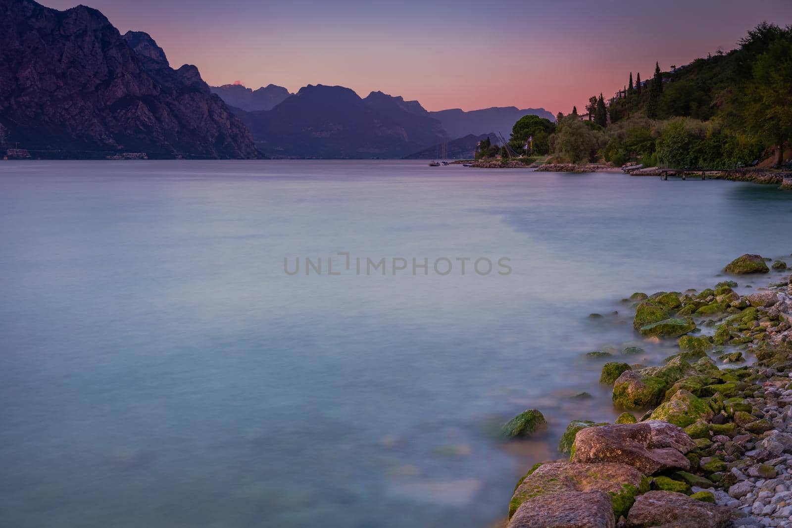Above idyllic Lake Garda in Malcesine at dramatic dawn, Italian alps, long exposure