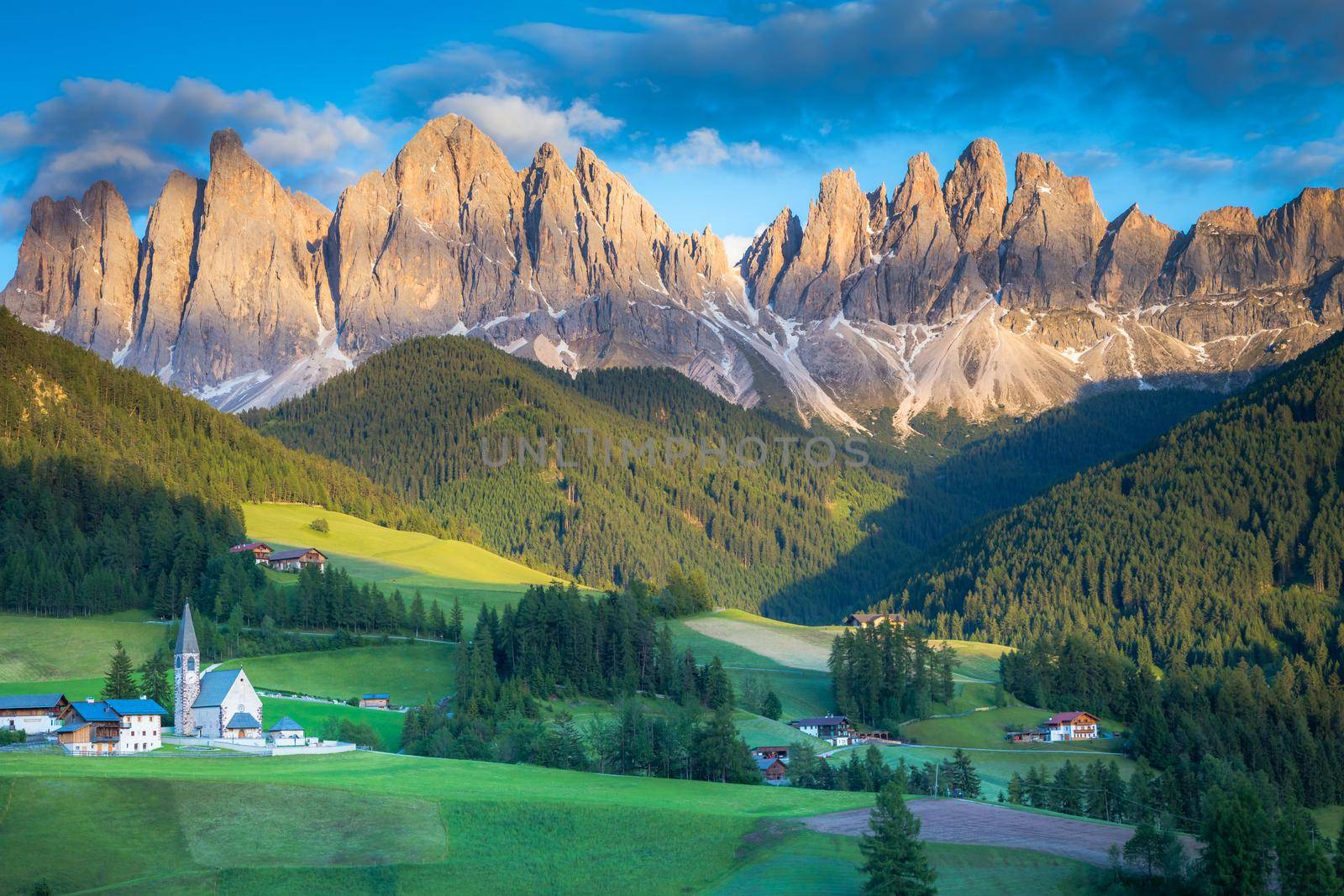 St. Magdalena village with famous church in Val di Funes at sunset, Dolomites , Italy