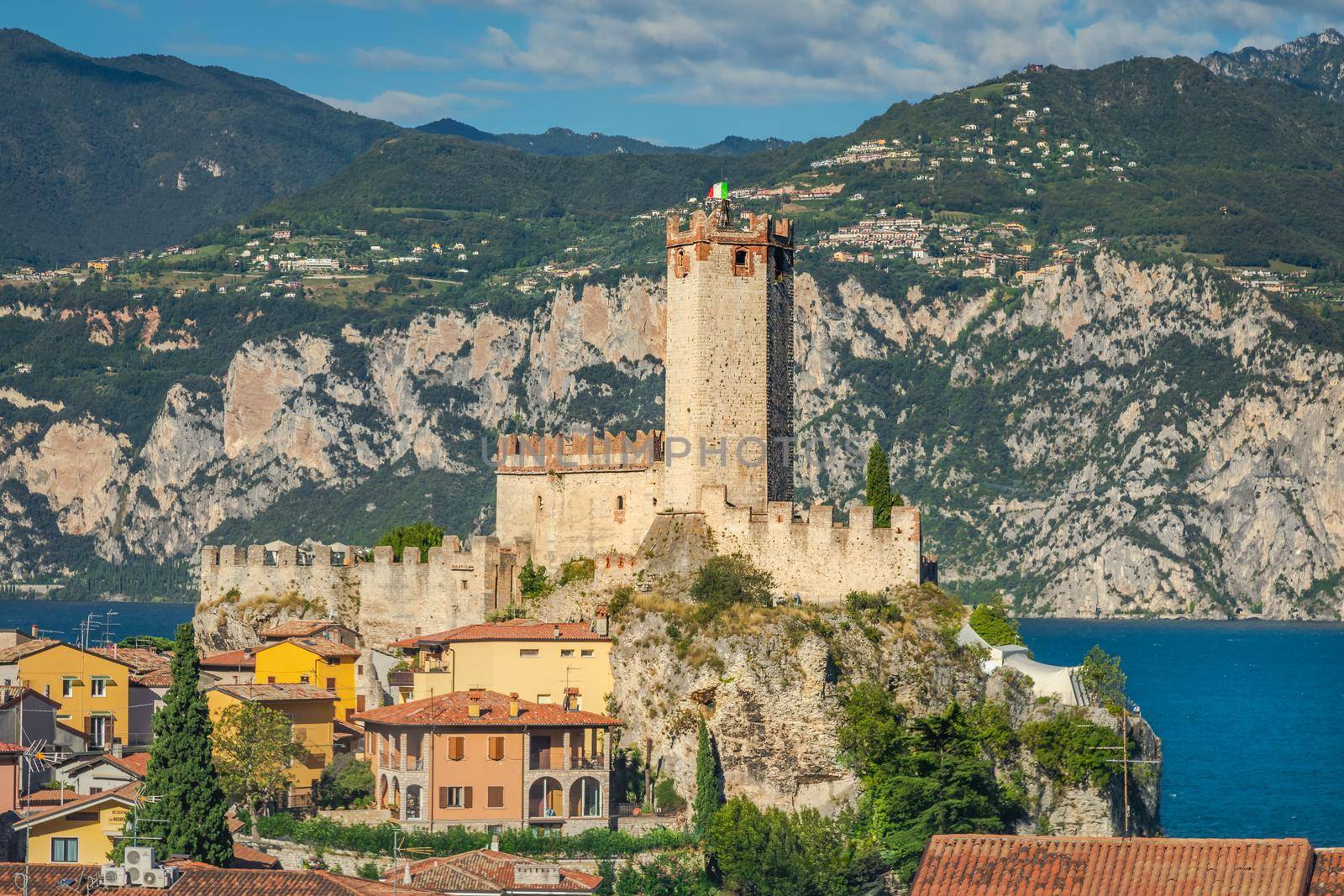 Lake Garda above Malcesine old town with Italian flag and mountain range