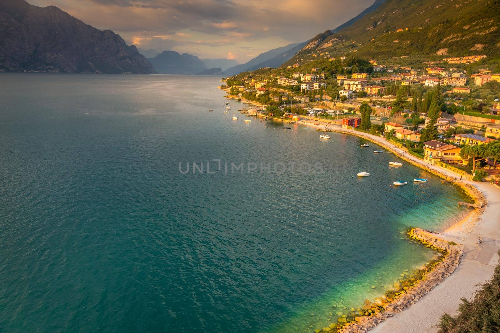 Above idyllic Lake Garda in Malcesine at dramatic sunset, Italian alps, long exposure