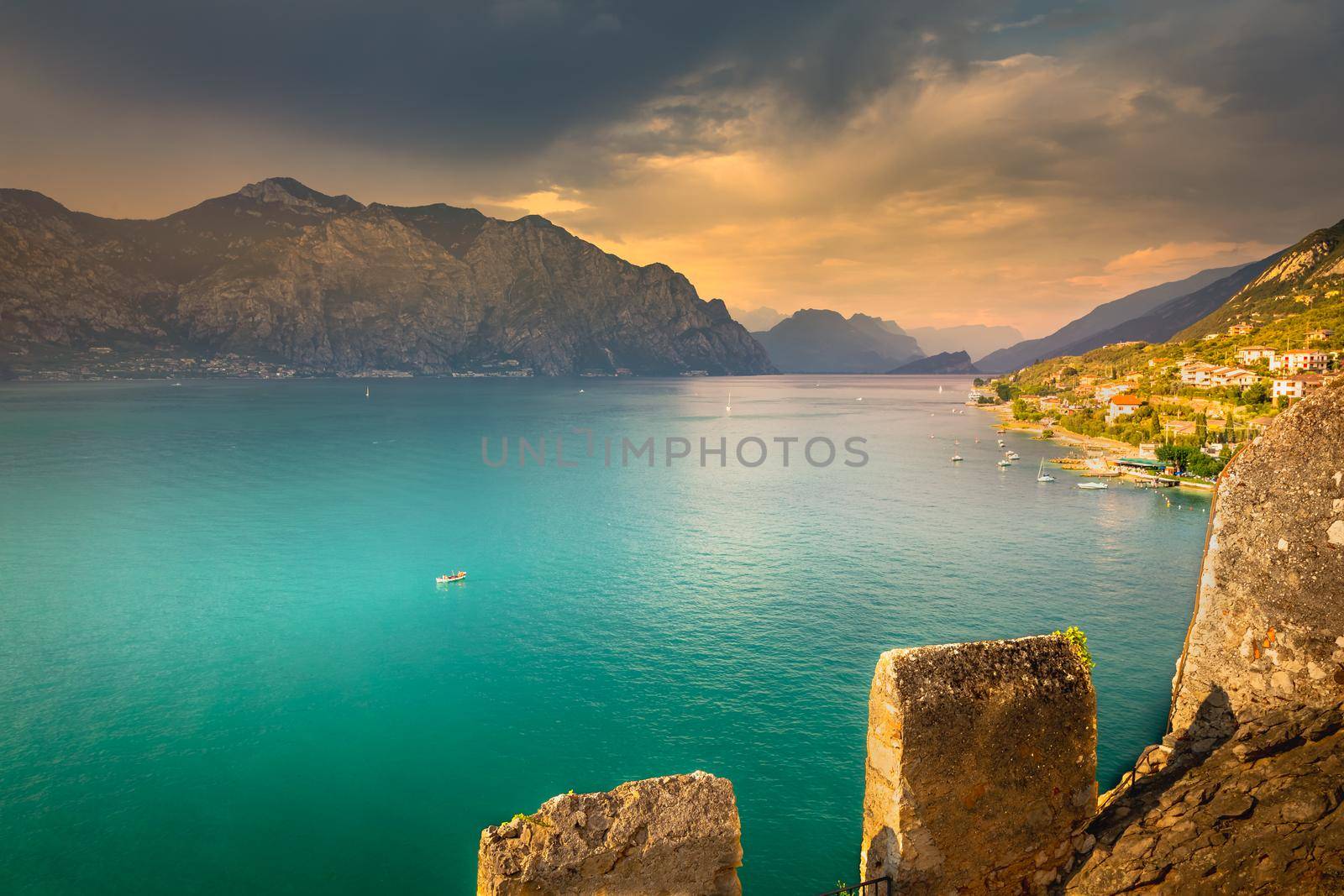 Above idyllic Lake Garda in Malcesine at dramatic sunset, northern Italian alps
