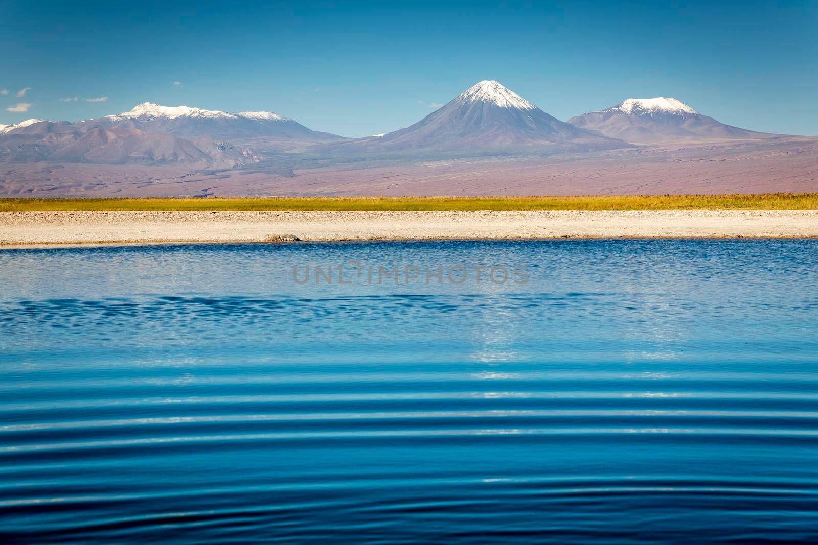 Licancabur volcanic landscape and salt lake reflection at sunset in Atacama Desert, Chile, South America