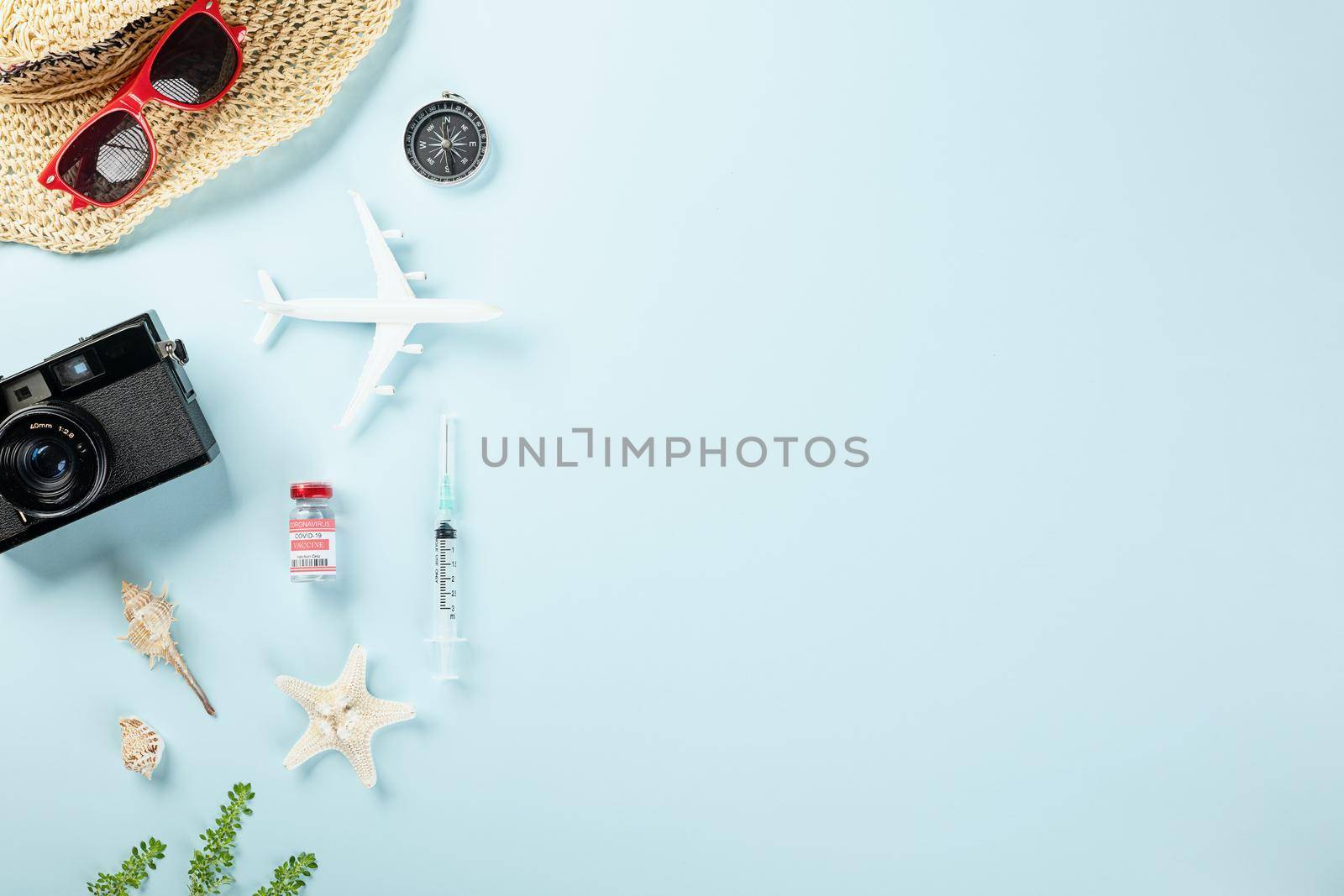 World Tourism Day during coronavirus pandemic, Travel accessories objects flat lay, studio shot isolated blue background with copy space, holiday trip vacation concept