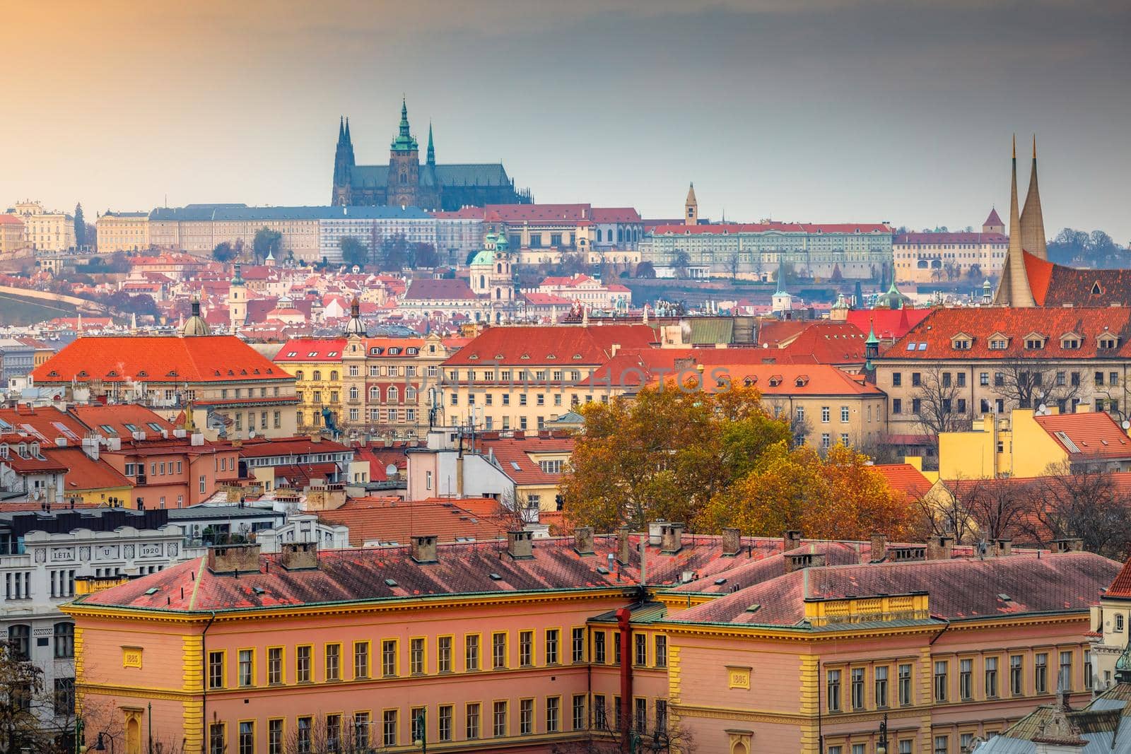 Above medieval Prague old town towers and domes at evening, Czech Republic