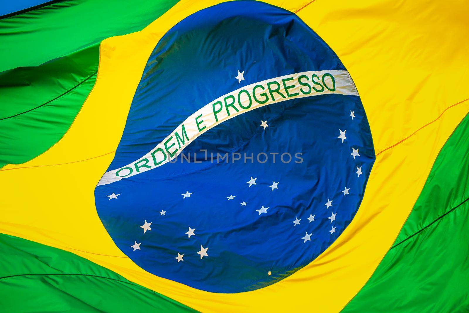 National flag of Brazil winding on blue sky in Brasilia, South America