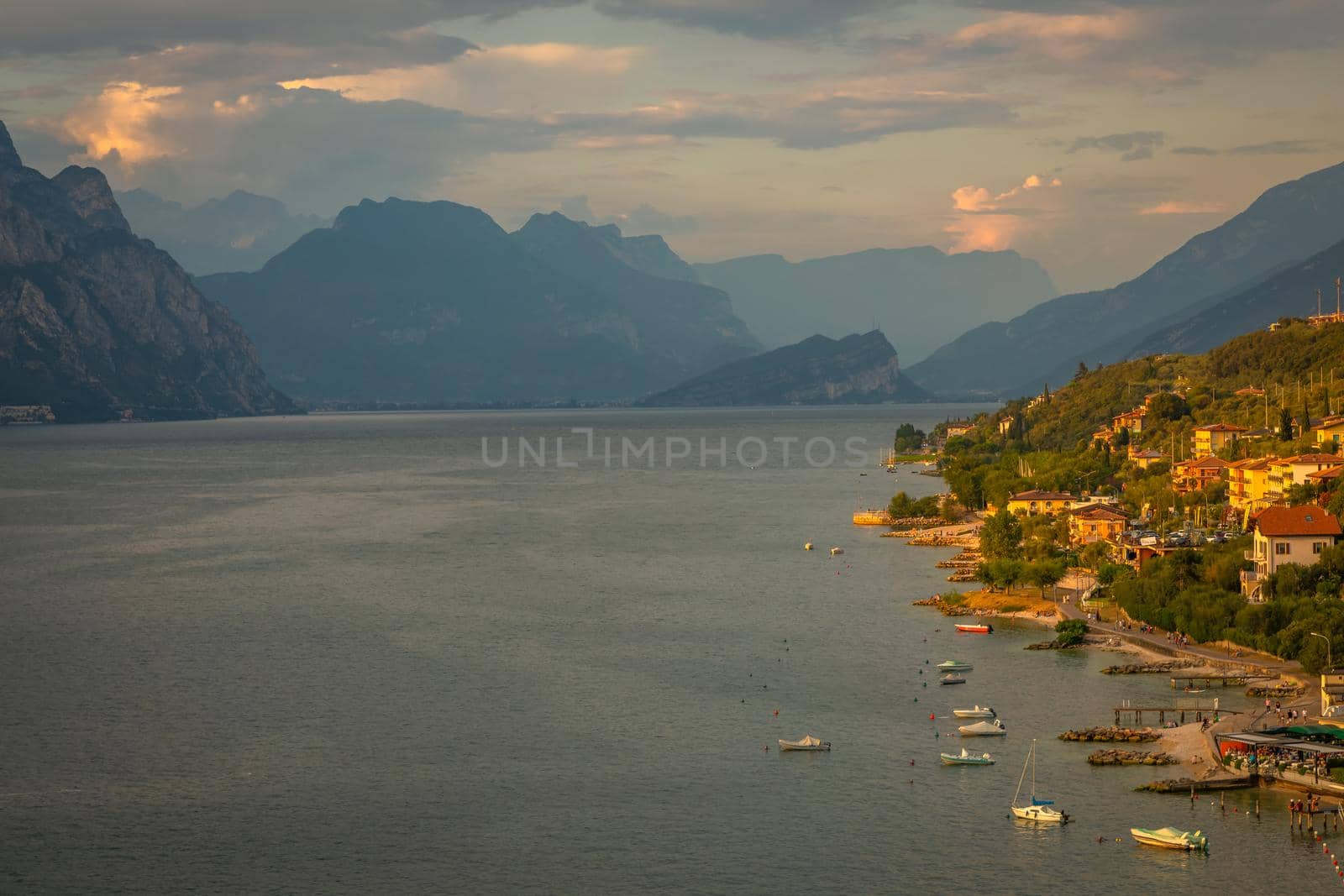 Above idyllic Lake Garda in Malcesine at dramatic sunset, Italian alps, long exposure