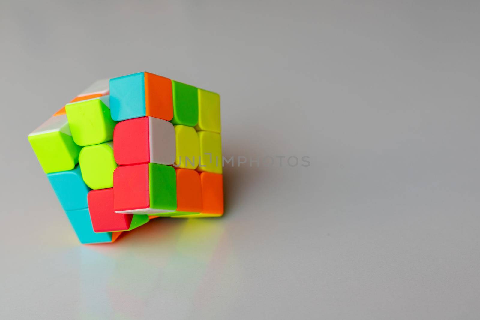 Puzzle cube game on a white background with copy space and selective focus by Bilalphotos