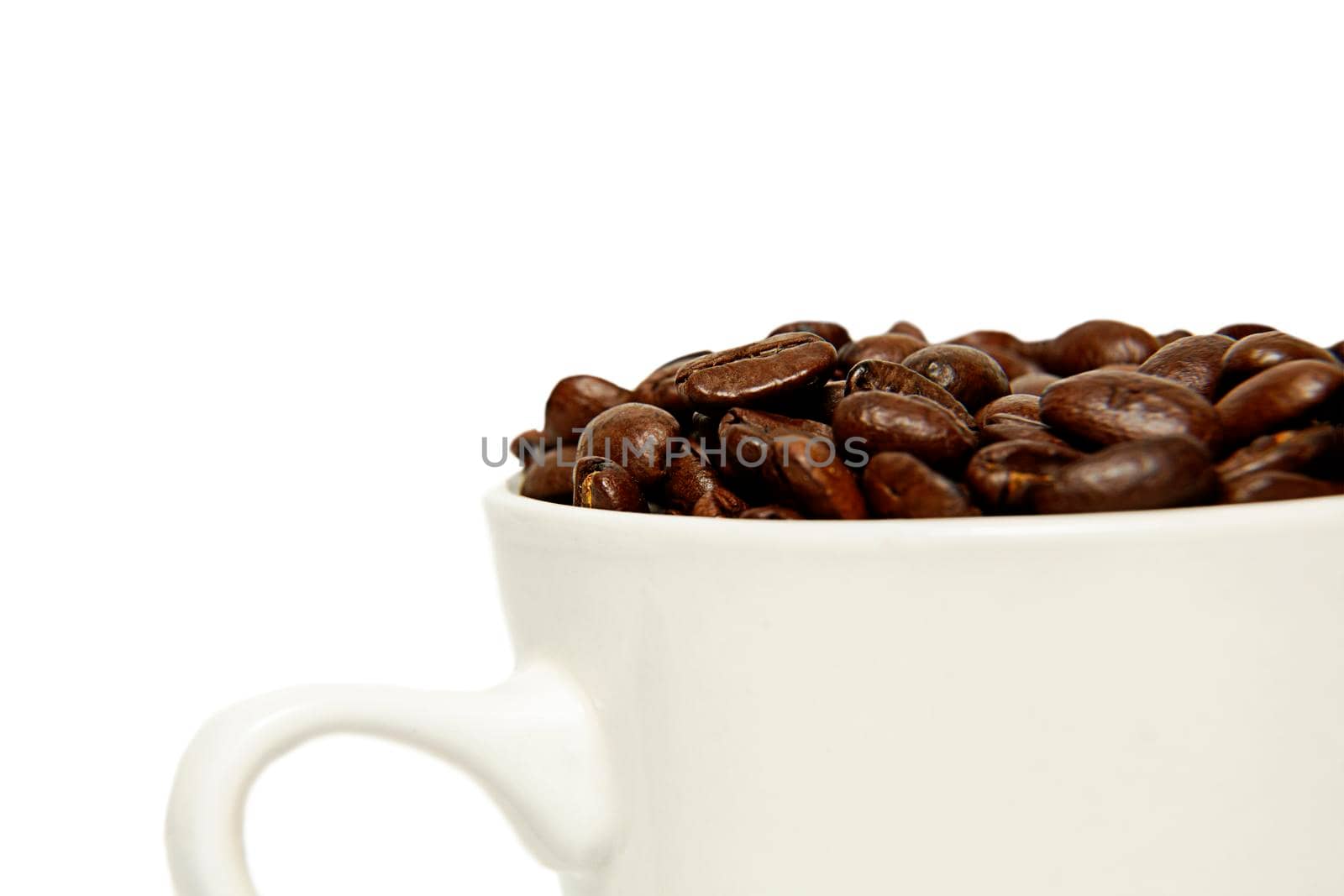 roasted coffee beans in a coffee mug. close-up. copy space