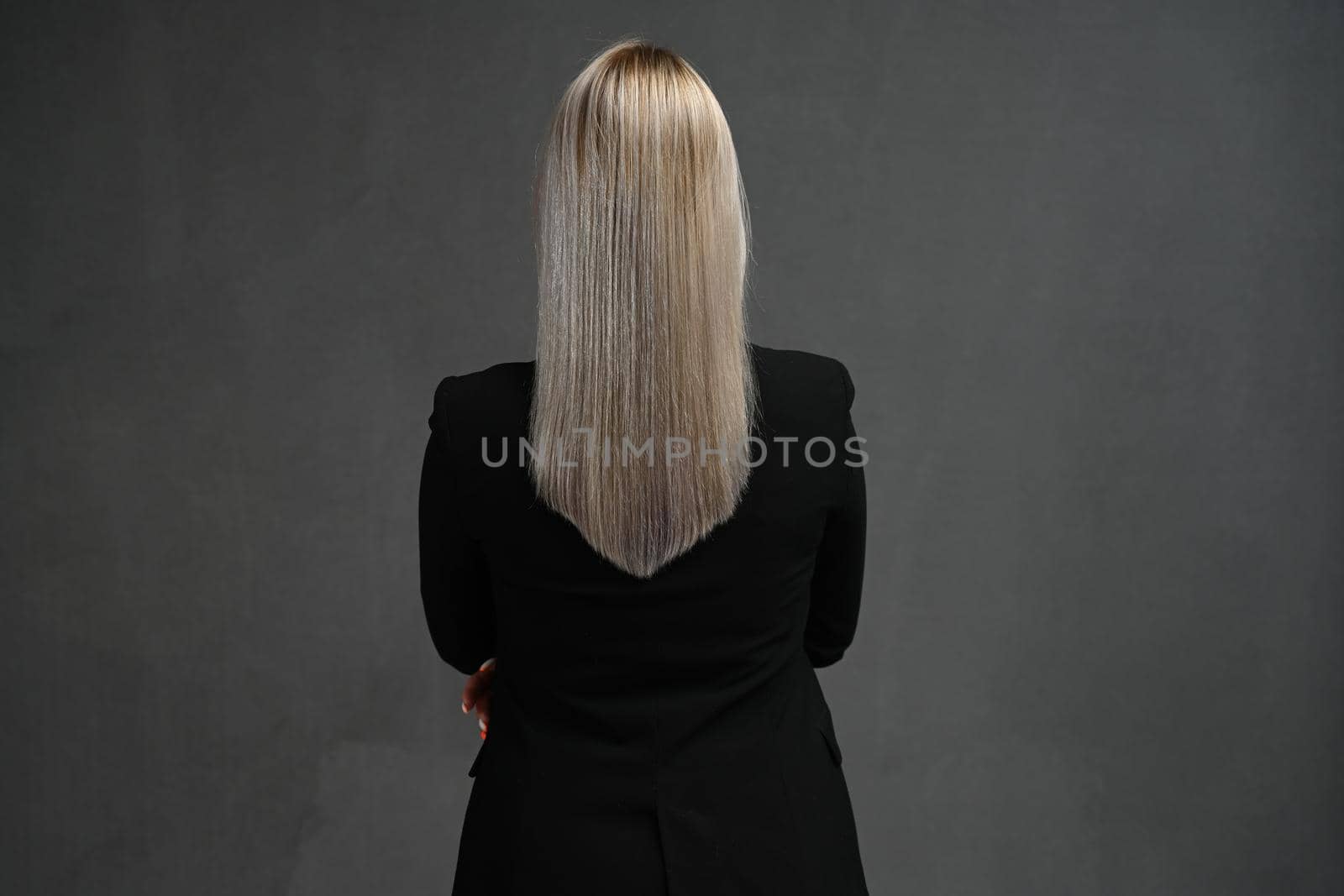 Back rear spine view photo of blond haired young woman pretty lovely natural hair isolated on gray background