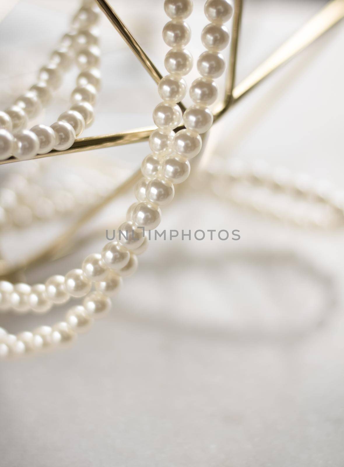 Pearl necklace on golden marble, ethical jewellery - luxury background, jewelry as a gift concept. Pearls are girl's best friends