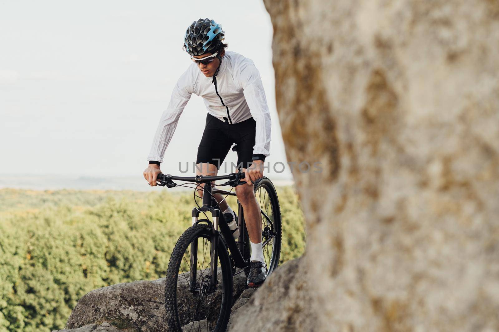 Equipped Professional Male Cyclist Riding Mountain Bike on the Trail Among Rocky Terrain, Adult Man Enjoying His Extreme Hobby Standing with Bicycle on Rock with Panoramic View
