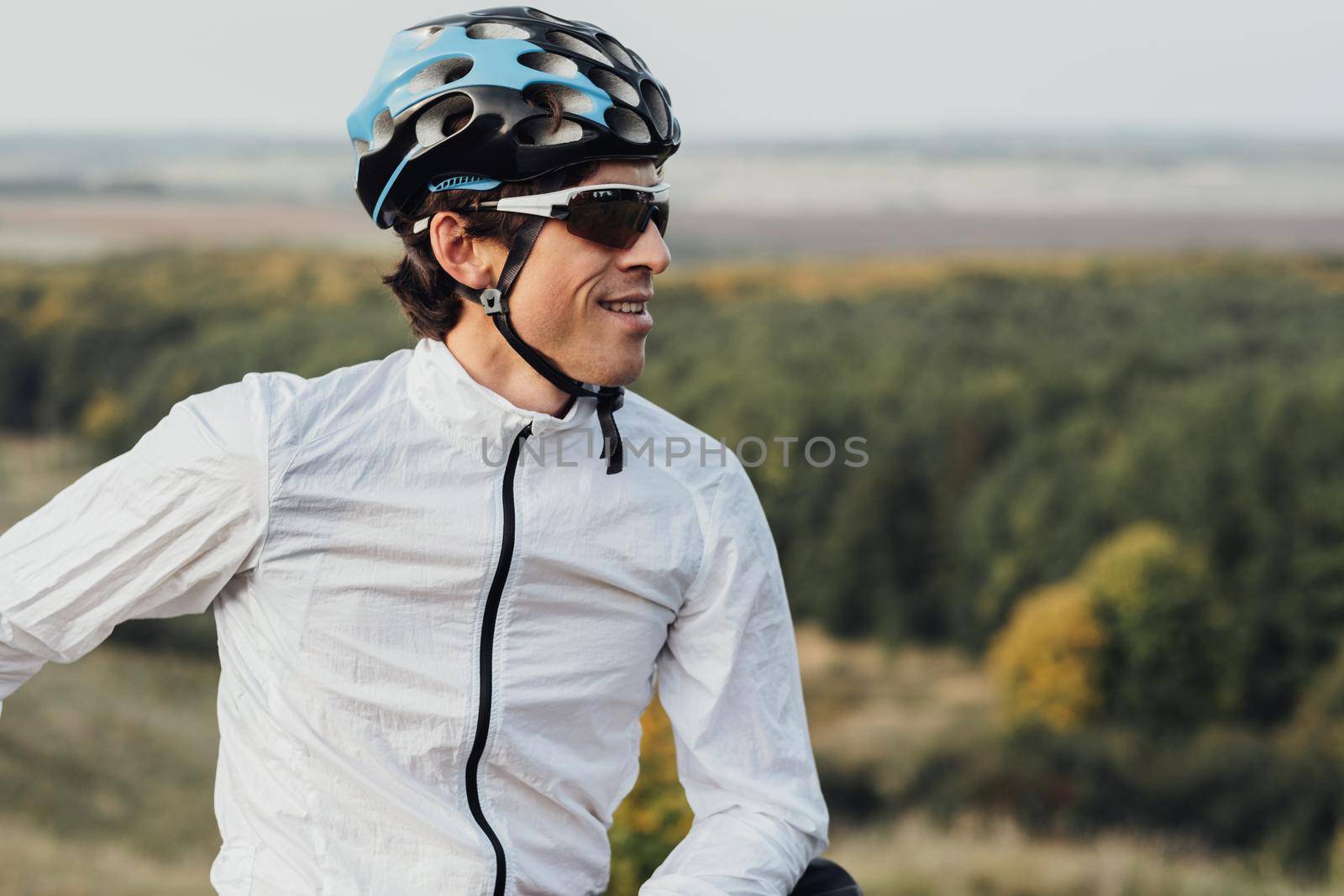 Portrait of Professional Male Cyclist, Adult Man Wearing Helmet and Protection Sport Glasses Looking Away, Copy Space