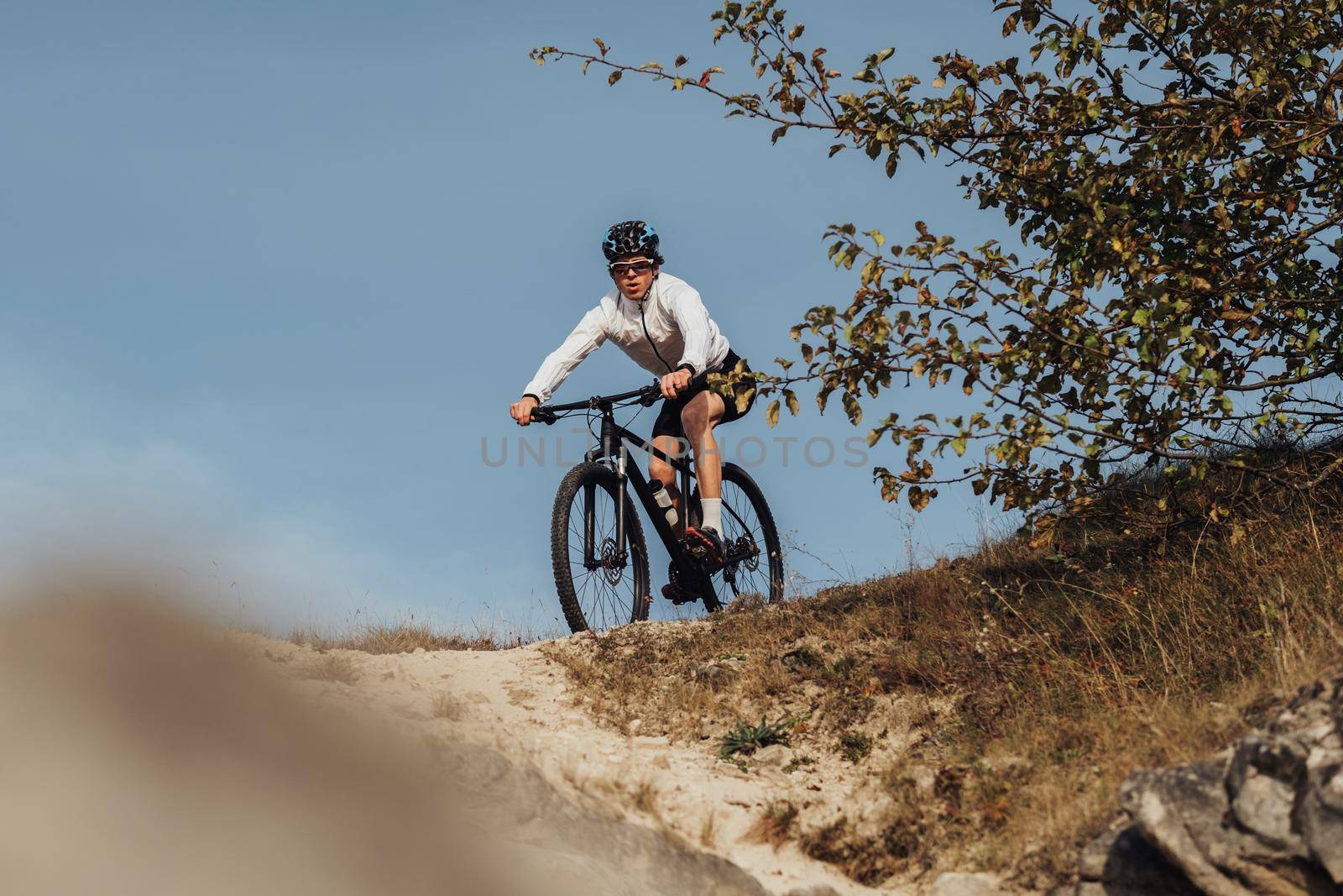 Equipped Professional Cyclist Descends a Slope on His Mountain Bike, Sportsman Going Down from Hill on Bicycle by Romvy