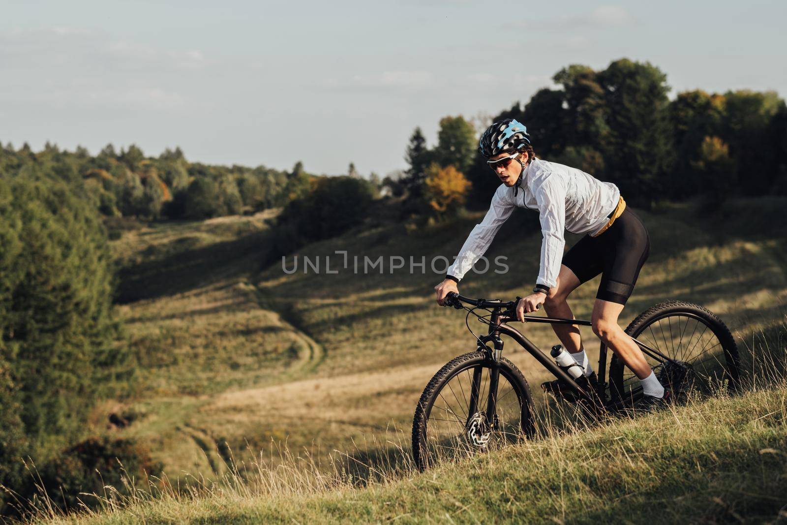 Professional Male Cyclist Riding Bike Outdoors, Adult Equipped Man on Bicycle on Trail, Copy Space