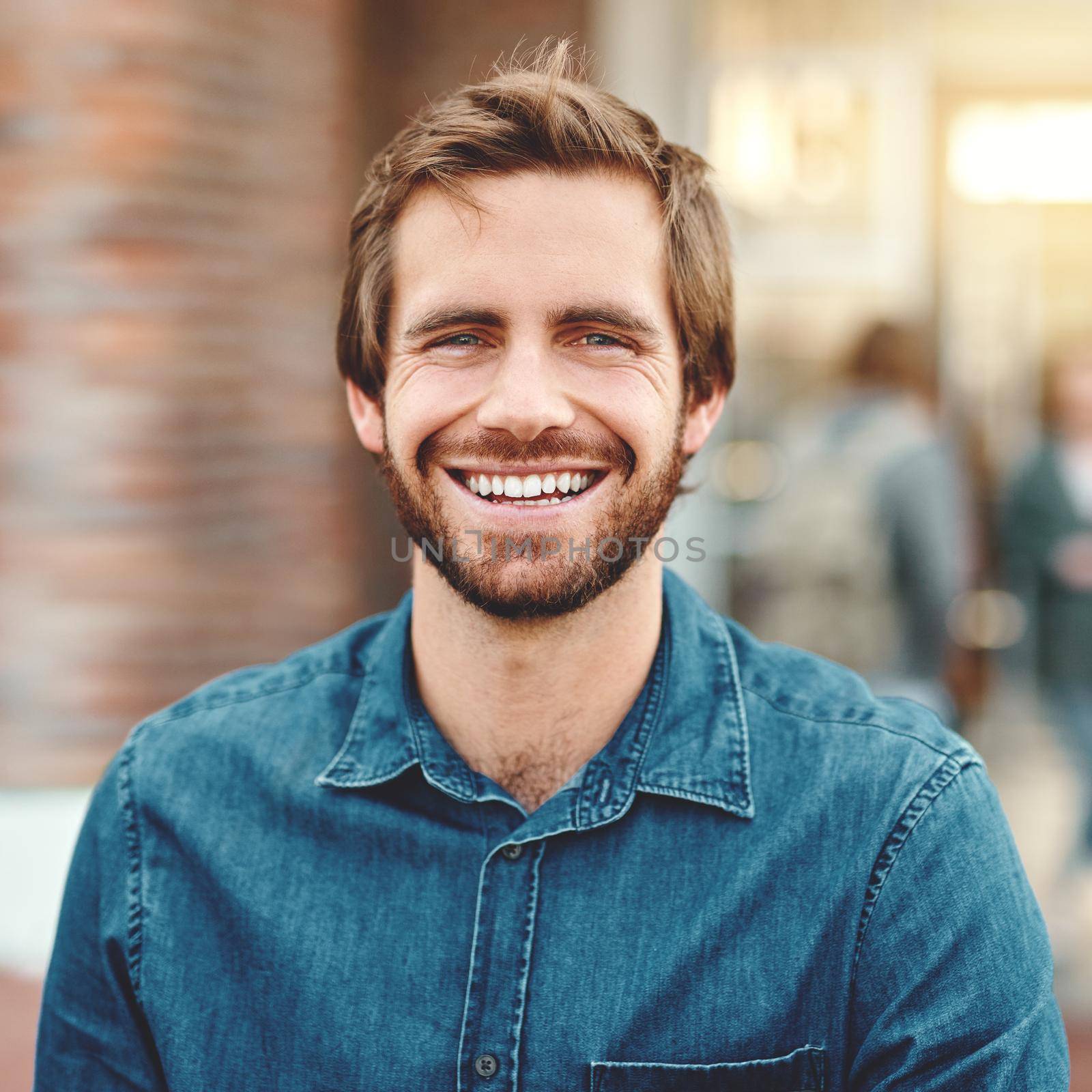 Im putting my future first. Portrait of a happy young man standing outdoors on campus. by YuriArcurs