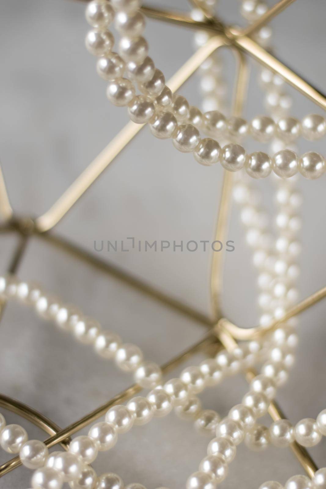 Pearl necklace on golden marble, ethical jewellery - luxury background, jewelry as a gift concept. Pearls are girl's best friends