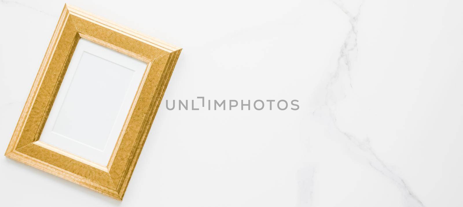 Golden photo frame on marble, flatlay - modern feminine, artwork mock up, luxury design concept. Decorate with chic and style