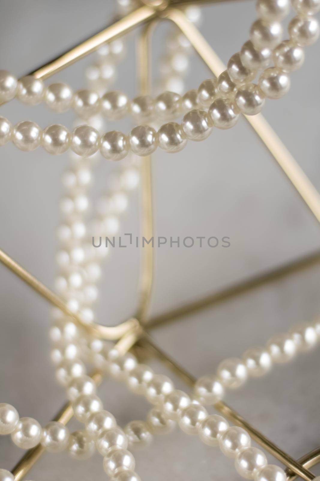 Pearl necklace on golden marble, ethical jewellery - luxury background, jewelry as a gift concept. Pearls are girl's best friends