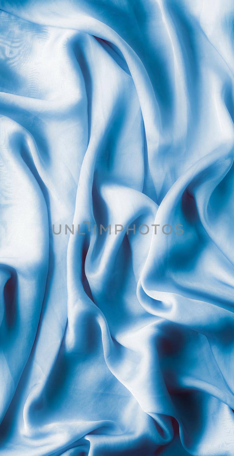 Blue soft silk waves, flatlay - elegant fabric textures, abstract backgrounds and modern pastel colours concept. Feel the touch of luxury