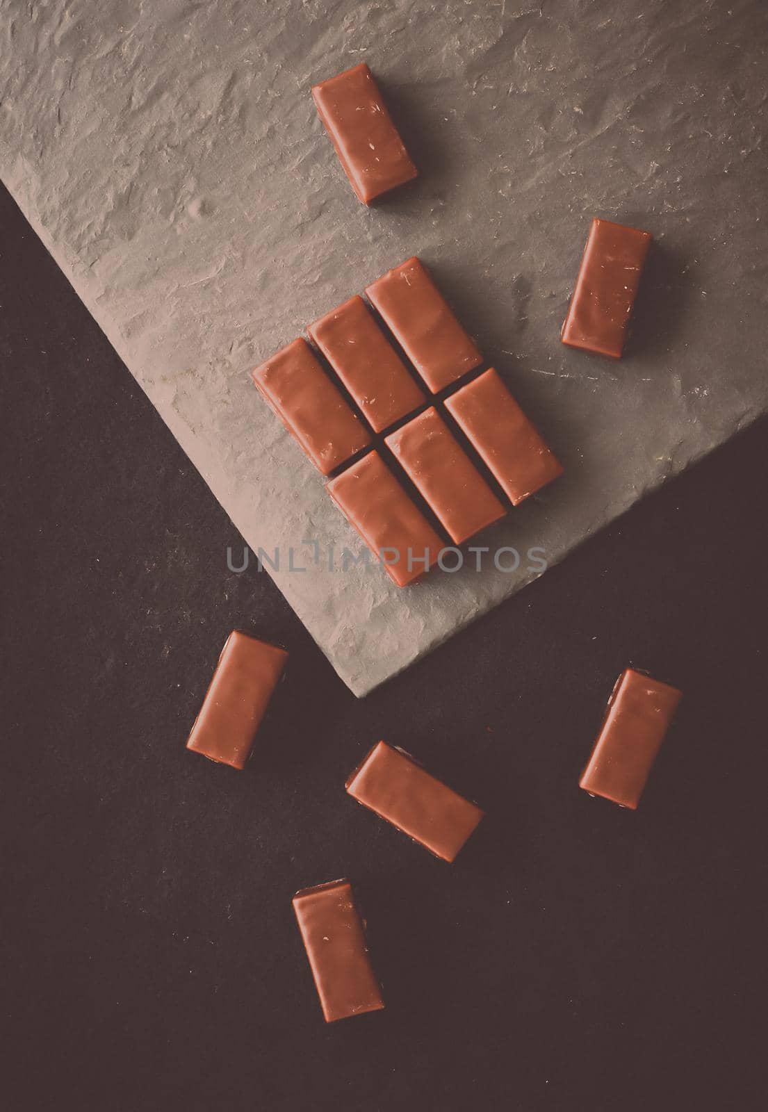 Sweet swiss chocolate candies on a stone tabletop, flatlay - desserts, confectionery and gluten-free organic food concept. All you need is chocolate