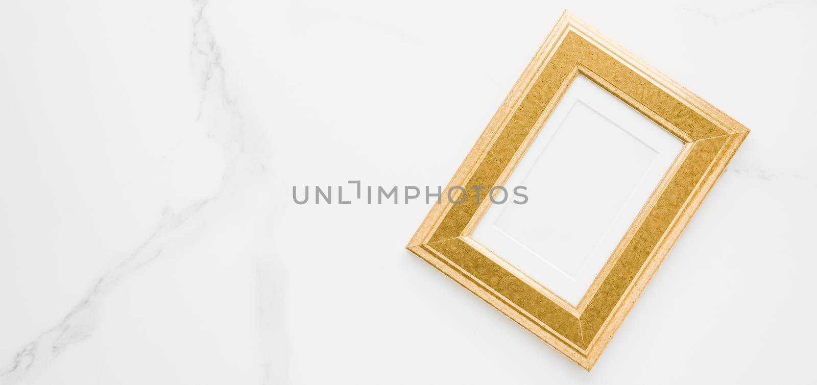 Golden photo frame on marble, flatlay - modern feminine, artwork mock up, luxury design concept. Decorate with chic and style