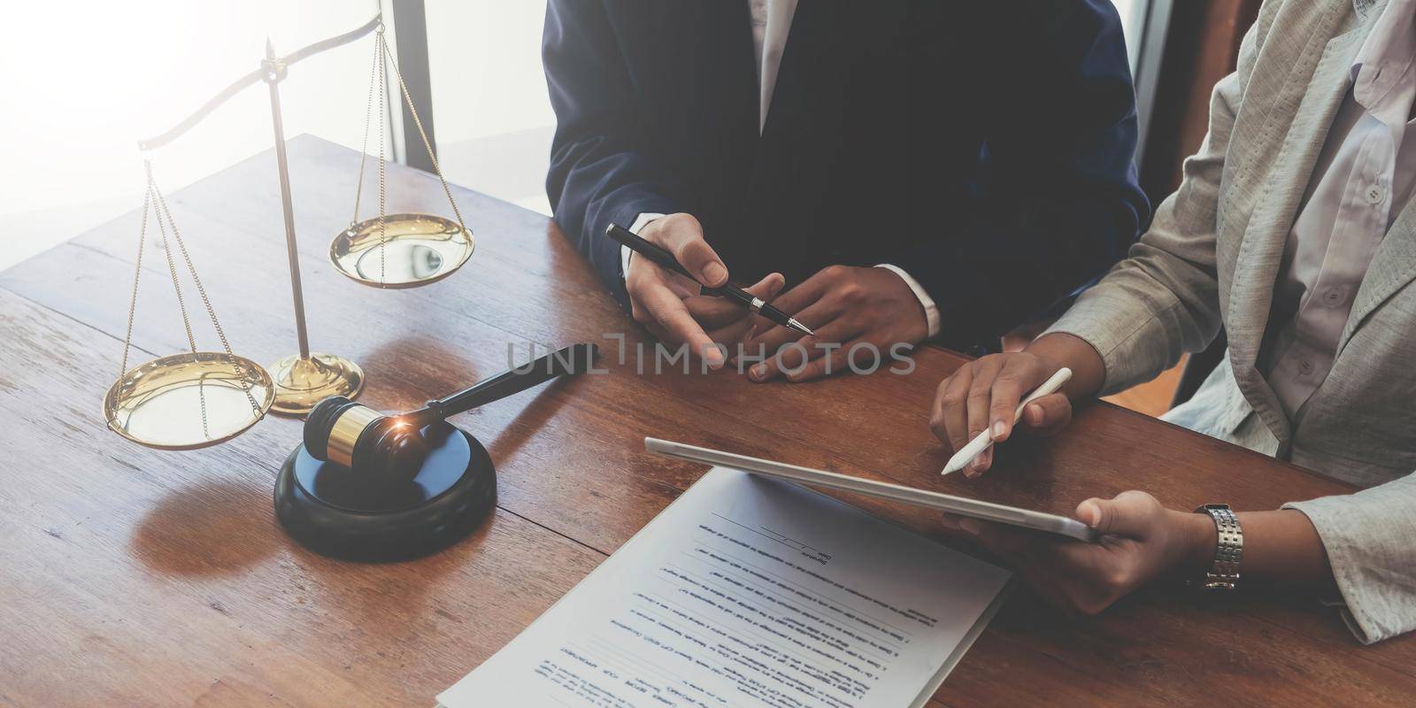 Consultation of Businessman or lawyer team meeting with client, Law and Legal services concept, Good service cooperation, Hands using tablet and laptop. by wichayada