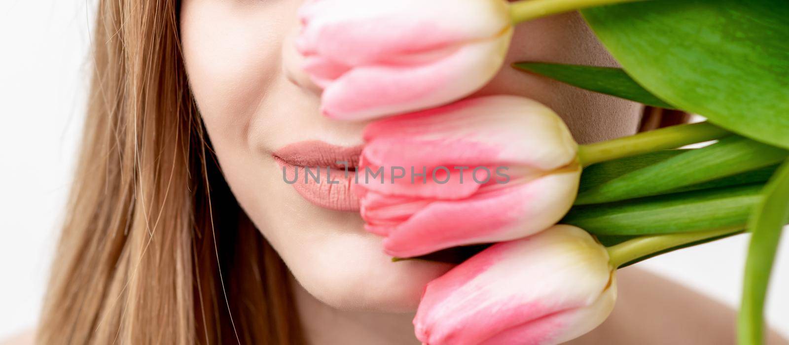 Young woman with pink tulips by okskukuruza