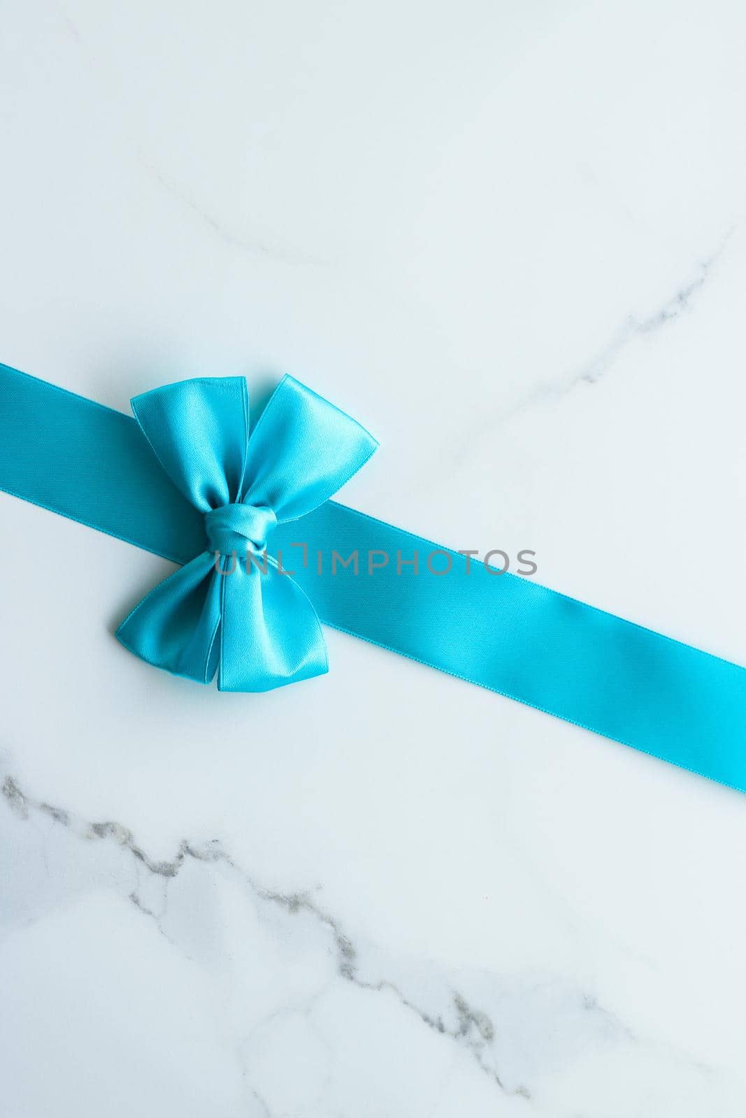 Holiday decor, feminine design and flatlay concept - Blue silk ribbon on marble, top view