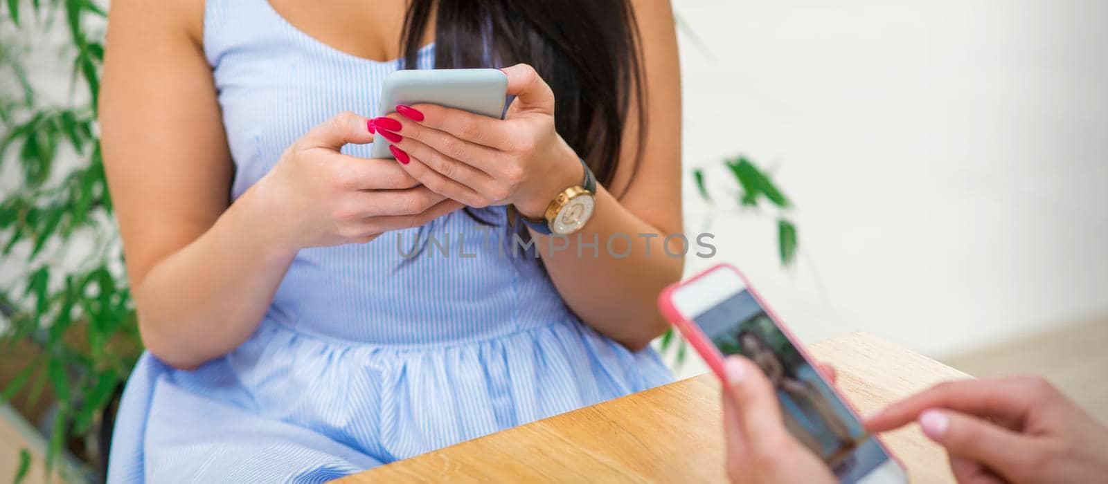 Young woman uses a smartphone by okskukuruza