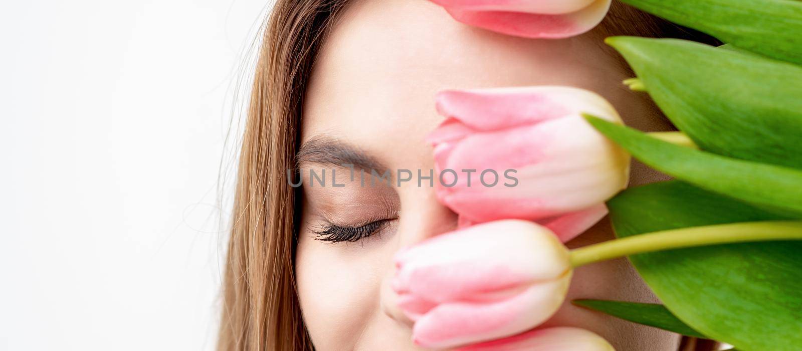 Young woman with pink tulips by okskukuruza
