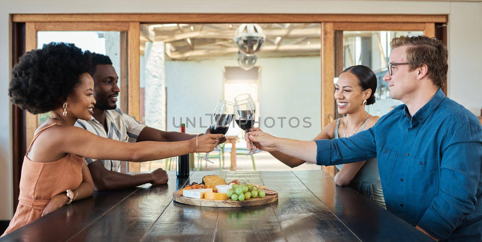 Double date of couples having dinner together and drinking wine at a restaurant celebrating and having fun. Romantic group of friends enjoying a lunch date in celebration of their love.