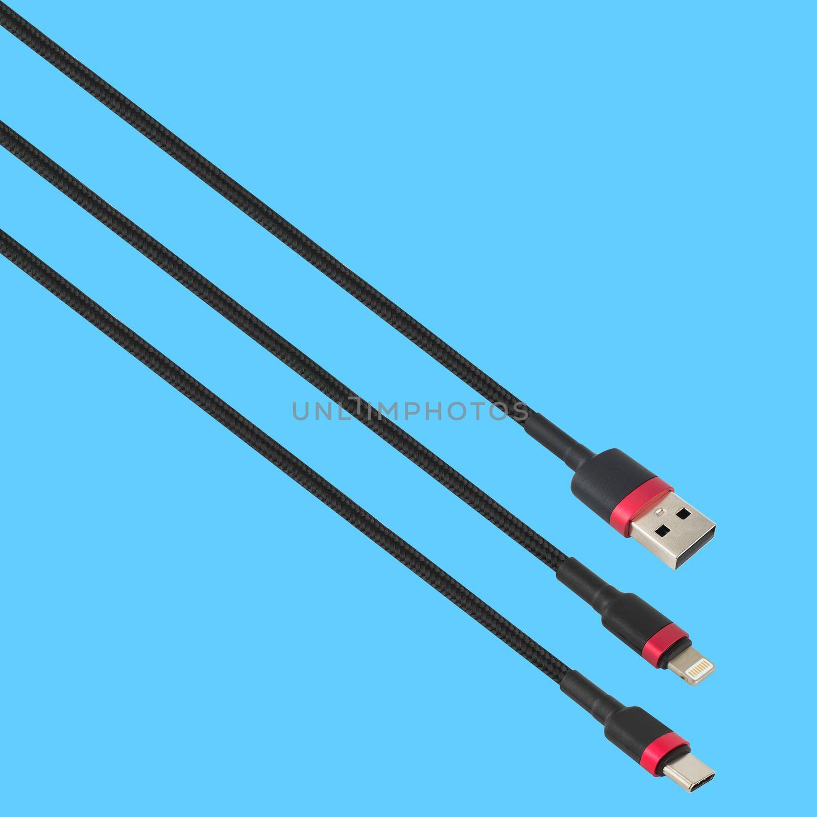 Cable with USB, Type-C and Lightning connector, isolated on a blue background