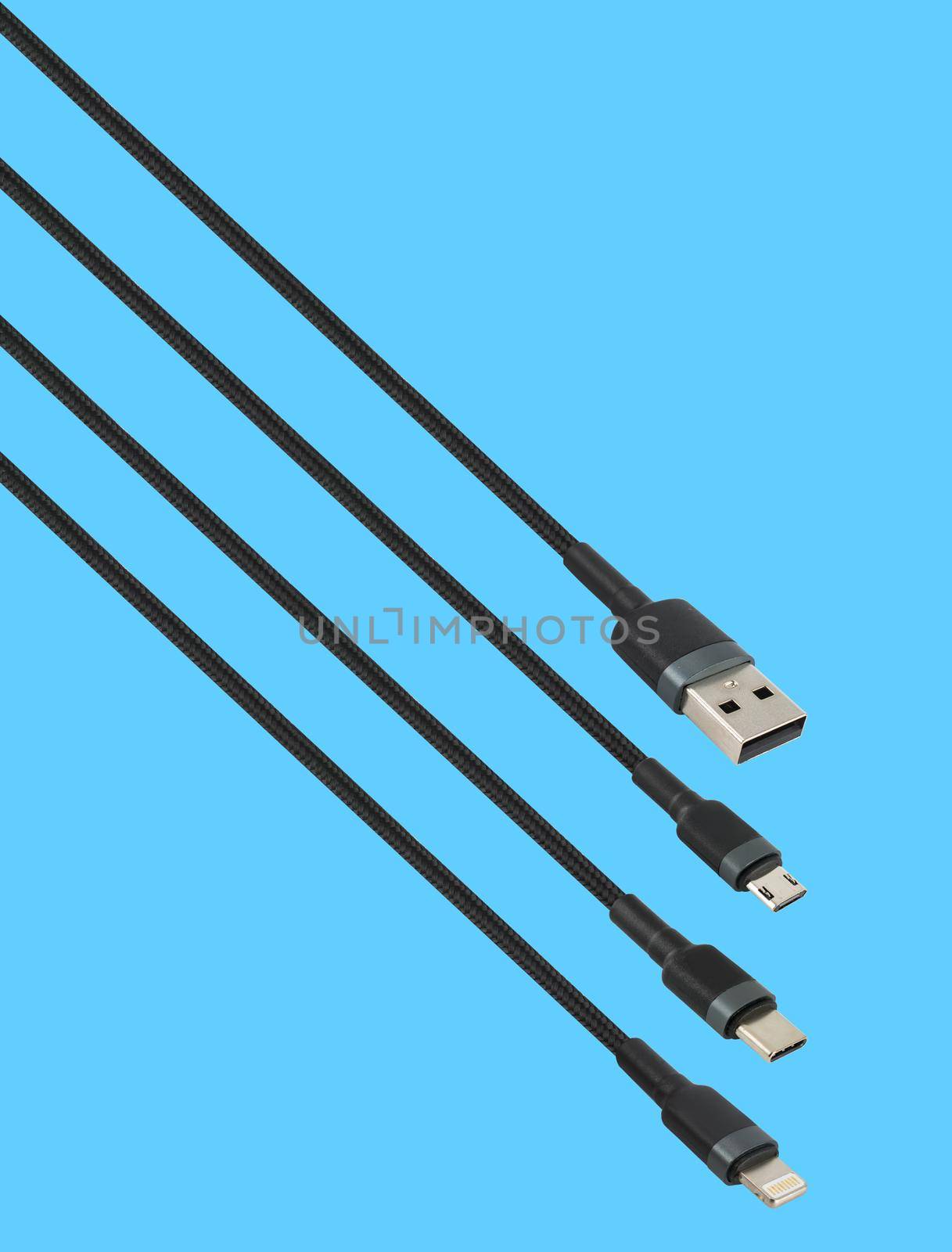 Cable with USB, micro USB, Lightning and Type-C connector, isolated on a blue background