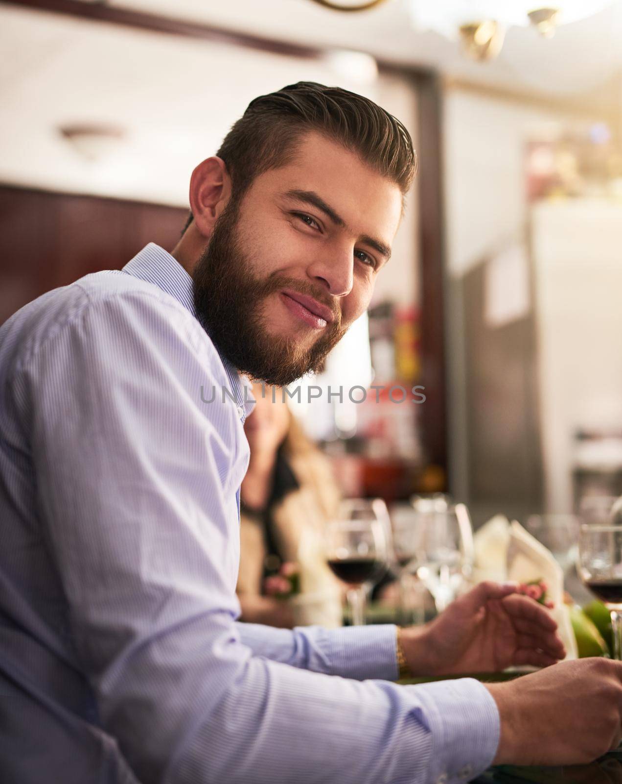 I enjoy our family lunches. Cropped portrait of a handsome young man eating during a family dinner at home. by YuriArcurs