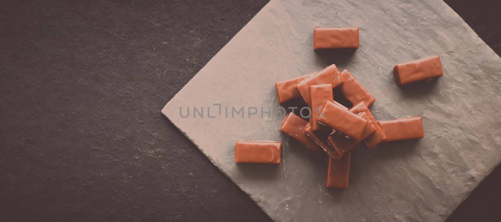 Sweet swiss chocolate candies on a stone tabletop, flatlay - desserts, confectionery and gluten-free organic food concept. All you need is chocolate