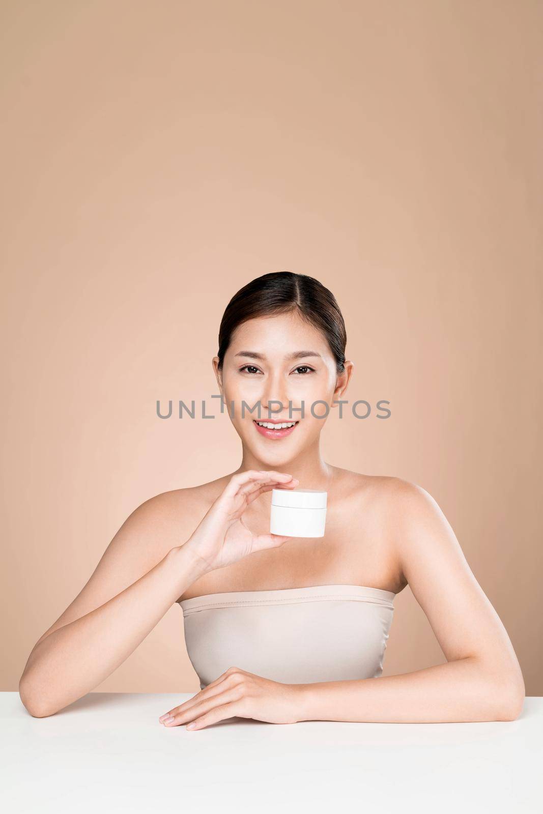 Ardent woman smiling holding mockup product for advertising text place. by biancoblue
