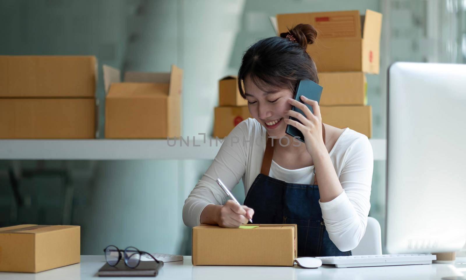 Startup small business entrepreneur SME, asian woman receive order on phone. Portrait young Asian small business owner home office, online sell marketing delivery, SME e-commerce telemarketing concept.