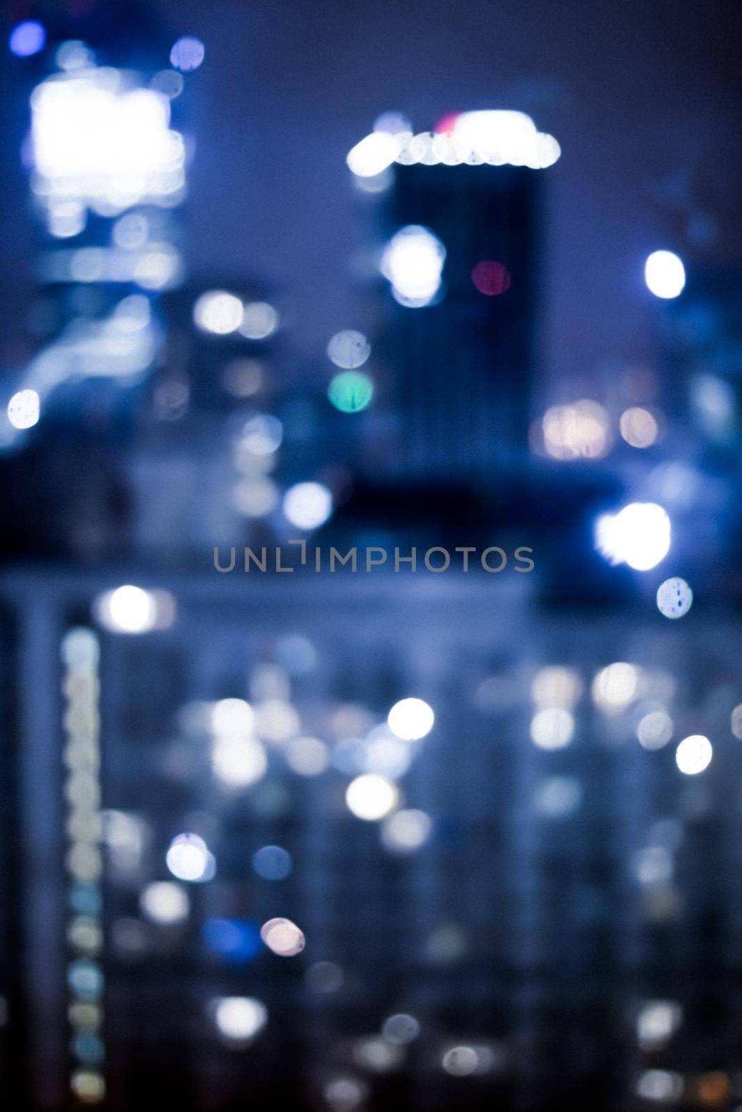 Blurry metropolitan district - night life, abstract background and modern dark tones concept. Big city comes alive at night