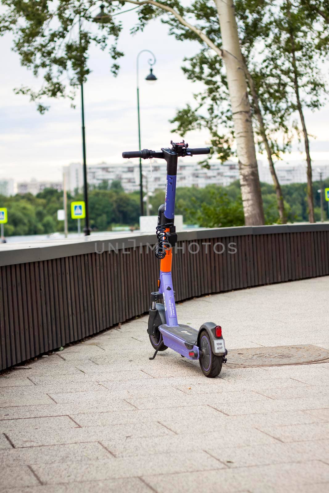 2022-07-17. Russia. Moscow. Northern River Station. A parked city electric scooter. Rent a scooter for a while for your rides. Moscow River