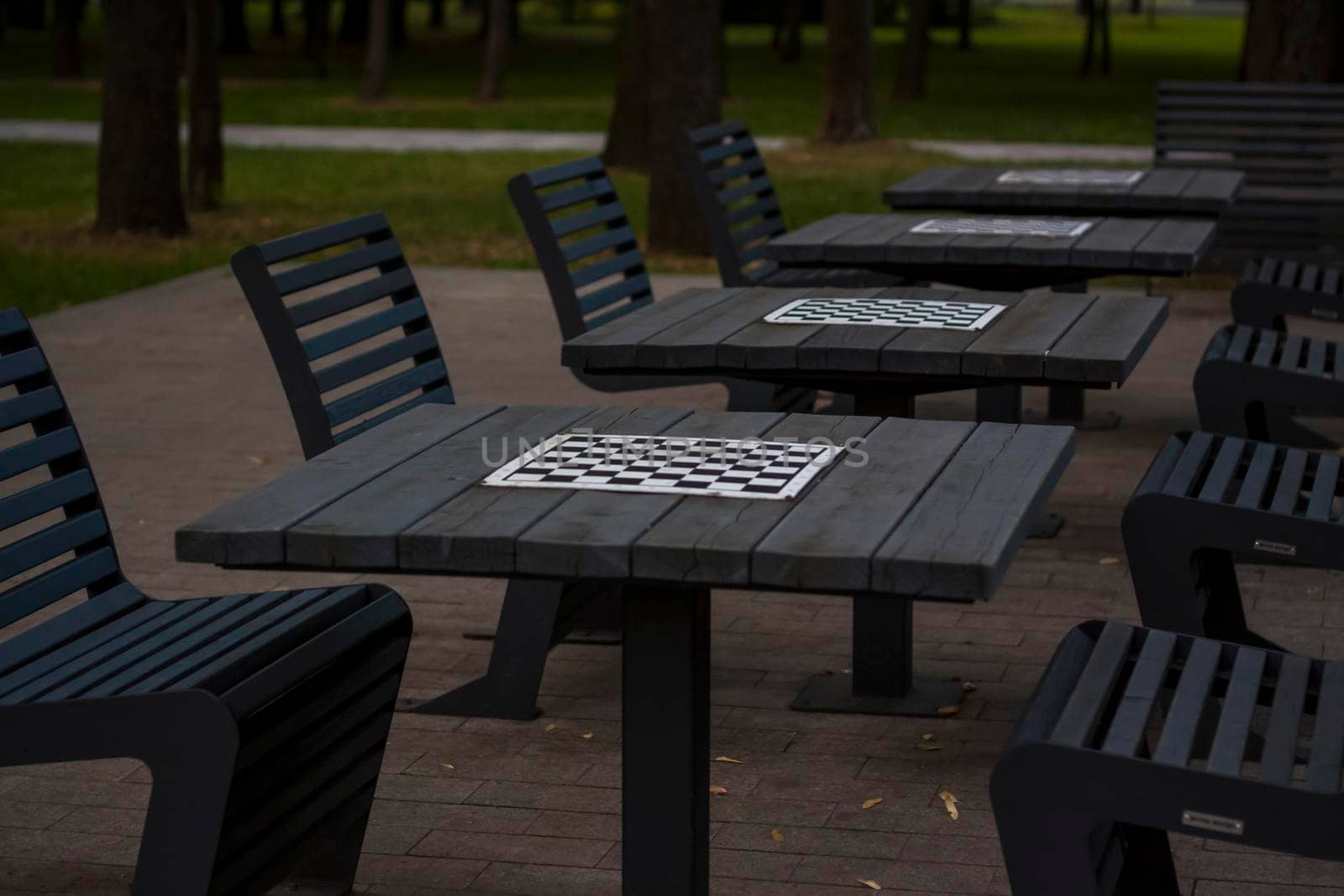 There are chess tables for everyone in the park. City playgrounds