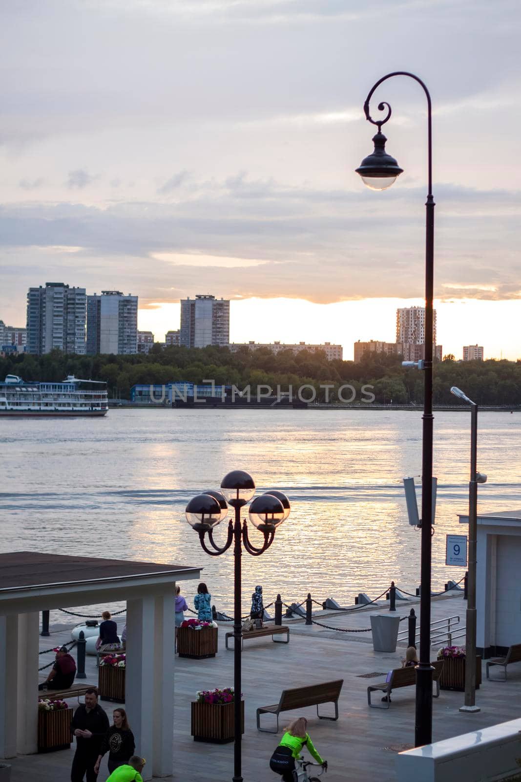 2022-07-17. Russia. Moscow. Northern River Station. Promenade. Walking along the embankment on scooters on a summer day.