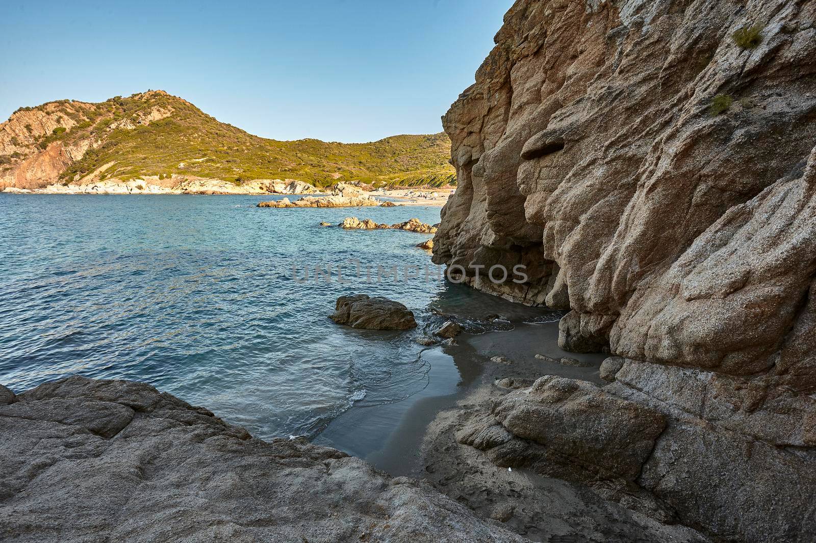 Exit of a natural cave on the beach of Cala Sa Figu in the south of Sardinia near Cagliari during the summer.