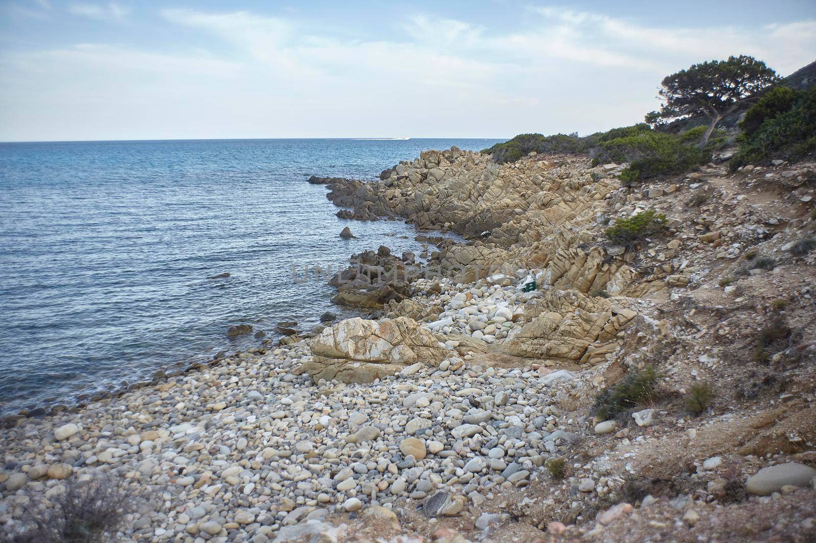 Magnificent view of Punta Molentis beach In Sardinia, taken during the summer: A completely uncontaminated and natural Mediterranean pebble beach.