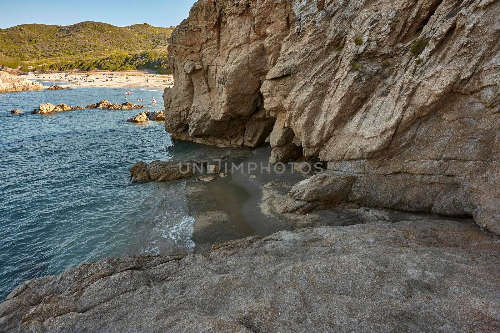 Natural cave carved on a rocky wall in the southern coast of Sardinia: Cala Sa Figu beach.