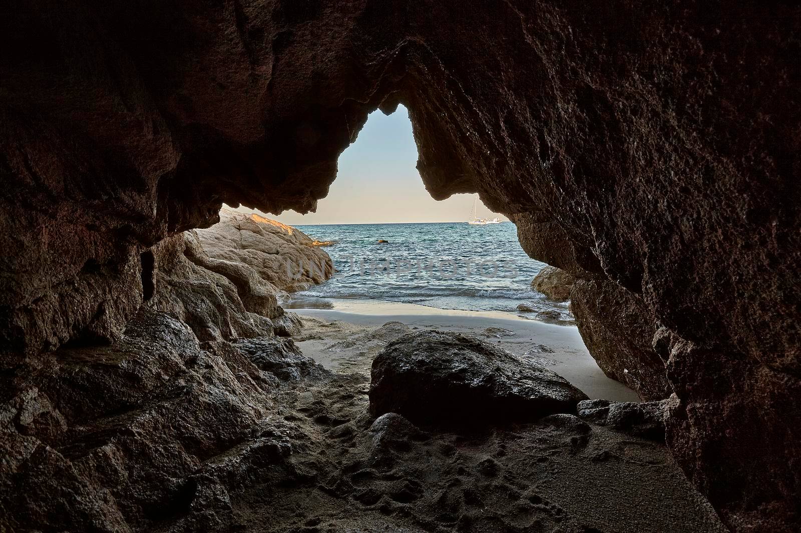 Rocky cave of a southern Sardinian beach overlooking the sea: a symbol of leaving your old being to cling to the new future.